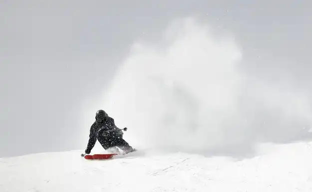 A skier having fun on the snowy slopes of houses for sale in Mont Tremblant